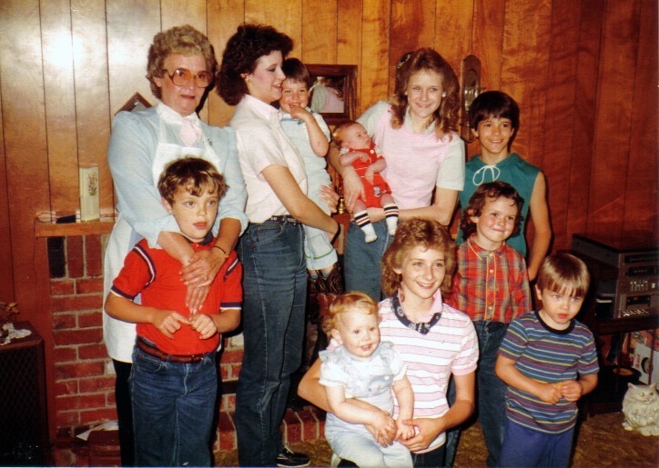 Young Garrett and his grandmother at left, among a crowd of nieces and nephews at a family gathering